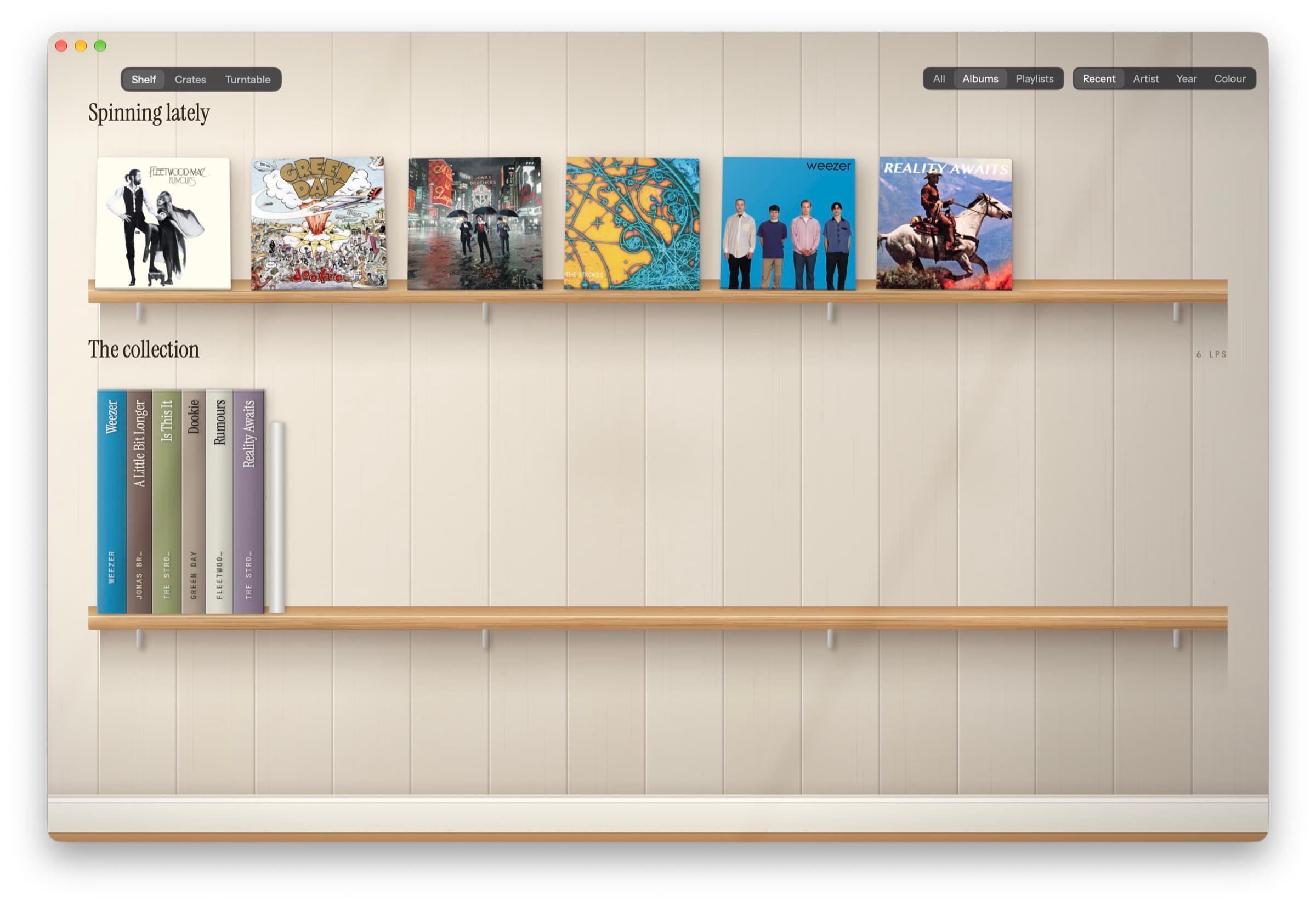The app's Shelf view: recently played album covers stand on a wooden shelf, with the rest of the collection shown as record spines below.